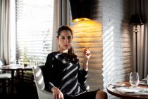 Portrait of sophisticated young woman in boutique hotel restaurant, Italy — Stock Photo