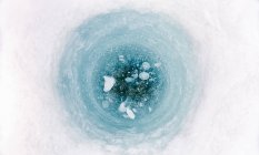 High angle close up of ice-fishing hole on frozen lake in Vasterbottens Lan, Sweden. — Stock Photo