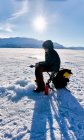 Boy ice-fishing on frozen lake in Vasterbottens Lan, Sweden. — Stock Photo