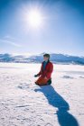 Boy kneeling on frozen lake in Vasterbottens Lan, Sweden. — Stock Photo