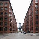 View along empty street towards Manhattan Bridge, New York City, USA during the Corona virus crisis. — Stock Photo