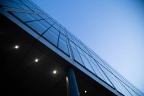 Low angle exterior view of glass facade of modern skyscraper. — Stock Photo