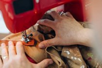 Man using sewing machine in creative studio, close-up — Stock Photo