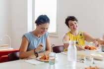 Friends enjoying lunch at home — Stock Photo
