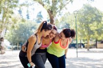 Friends exercising and laughing in park — Stock Photo