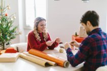 Couple preparing Christmas decorations at home — Stock Photo