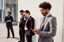 Mixed race group of businessmen hanging out together in town. — Stock Photo