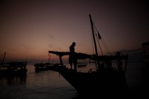 Silhouette of fisherman on boat — Stock Photo