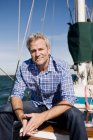 Portrait of man on yacht wearing checked shirt — Stock Photo