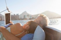 Couple on yacht with digital tablet — Stock Photo