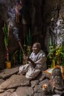 Devotee nun, lighting incense and offering prayers at Preah Khan Temple, Angkor, Cambodia — Stock Photo