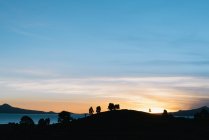 Silhouetted view of Lake Titicaca at sunset, Anapia, Peru, South America — Stock Photo