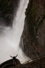 High angle view of male tourist at Pailon del Diablo waterfall, — Stock Photo