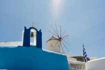 Vista ad angolo basso della chiesa e del vecchio mulino a vento, Oia, Santorini, Grecia — Foto stock