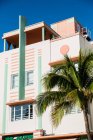 Low angle view of art deco building and palm tree, Ocean Drive, USA — Stock Photo