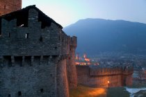 Muralla de la ciudad de Bellinzona iluminada de noche, Bellinzona, Ticino - foto de stock