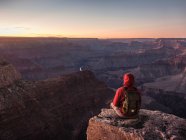 Homem sentado na borda de South Rim, Grand Canyon National Park loo — Fotografia de Stock