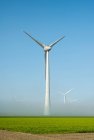 Offshore wind turbines standing in fog on the IJsselmeer inland — Stock Photo