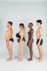 Giovani che indossano biancheria intima, in piedi in fila — Foto stock