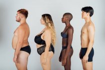 Young people wearing underwear, standing in a row — Stock Photo