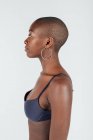 Portrait of a young woman with shaved head, wearing bra — Stock Photo