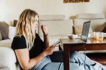 Mujer joven aprendiendo en línea - foto de stock