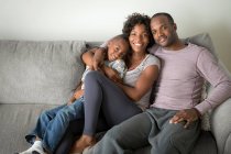 Portrait of parents and son sitting on sofa — Stock Photo