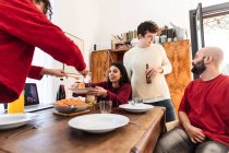 Friends sharing meal at home, having video call — Stock Photo