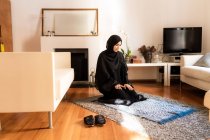 Jovem mulher muçulmana ajoelhada durante a oração — Fotografia de Stock