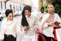 Amici di sesso femminile in viaggio di shopping, guardando il telefono — Foto stock