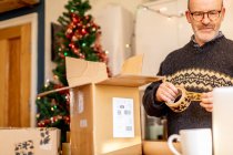 Man with Christmas delivery parcel — Stock Photo