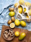 Citrus fruits in net bag with ginger roots — Stock Photo
