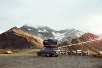 Italia, Austria, Auto con tenda sul tetto nel paesaggio montano — Foto stock