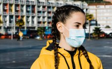 Portrait of teenage (16-17) girl wearing flu mask — Stock Photo