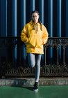 Portrait of teenage (16-17) girl in yellow coat — Stock Photo