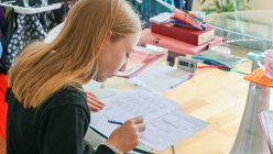 Велика Британія, Суррей, дівчинка (10-11) роблять домашнє завдання — стокове фото