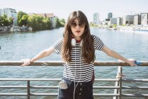 Germany, Berlin, Portrait of young woman by river — Stock Photo