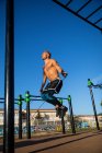 Spain, Mallorca, Man exercising at outdoor gym — Stock Photo