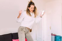 Italy, Young woman dancing at home — Stock Photo