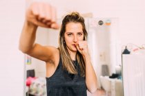 Italy, Portrait of young woman exercising at home — Stock Photo