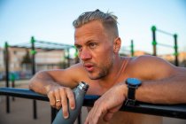 Spain, Mallorca, Man resting after workout at outdoor gym — Stock Photo