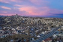 Turkey, Cappadocia, Aerial view of rock formations and village at dusk — Stock Photo