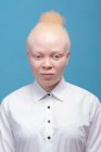 Studio portrait of albino woman in white shirt — Stock Photo