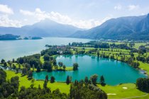 Austria, Salzburg, Aerial view of Mondsee lake and golf course — Stock Photo