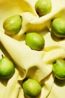Overhead view of pears on yellow table cloth — Stock Photo
