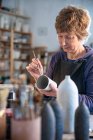 Espagne, Baléares, Femme peinture céramique dans l'atelier — Photo de stock