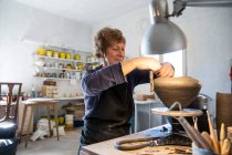 Spain, Baleares, Woman making ceramics in workshop — Stock Photo