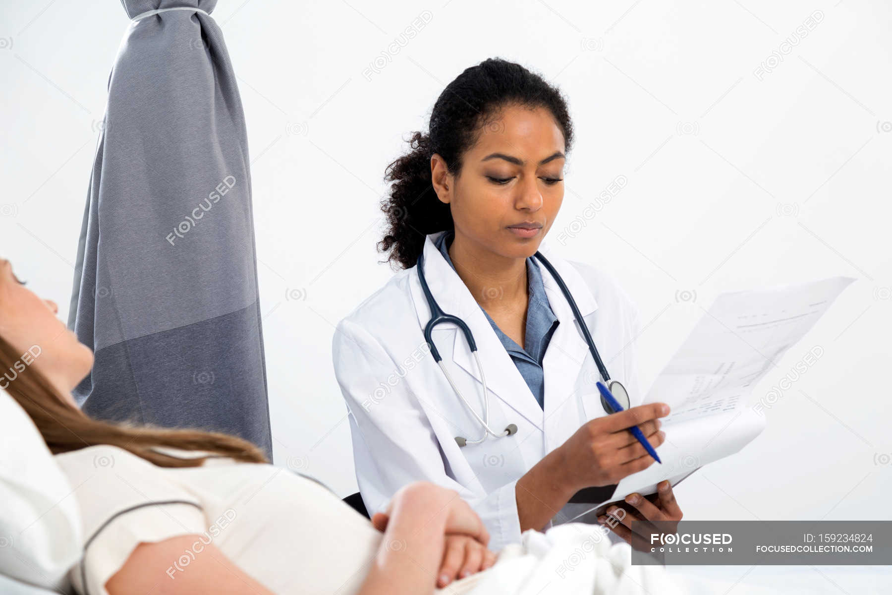 doctor-consulting-with-patient-clinic-medical-examination-stock