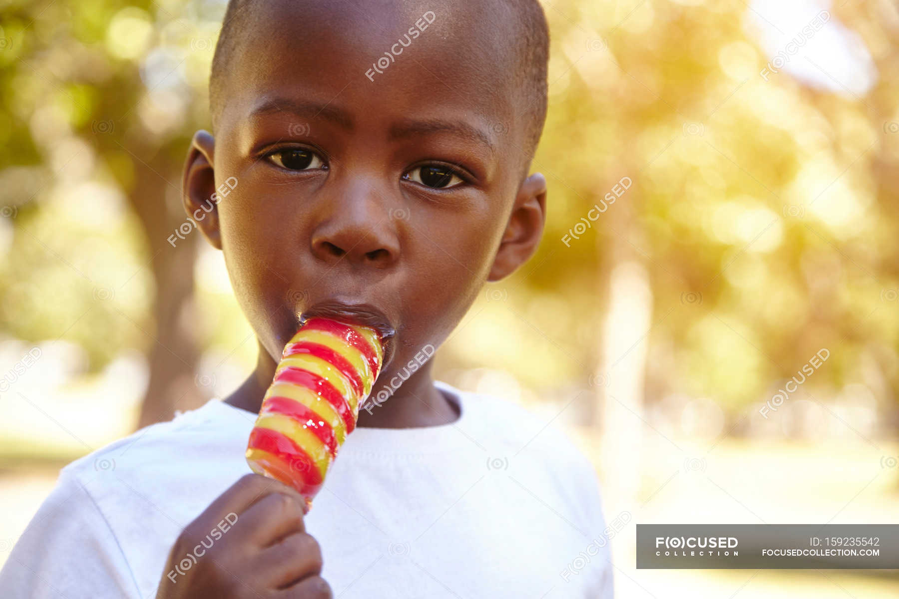 Boy eating ice lolly — toddler, hot Stock Photo 159235542