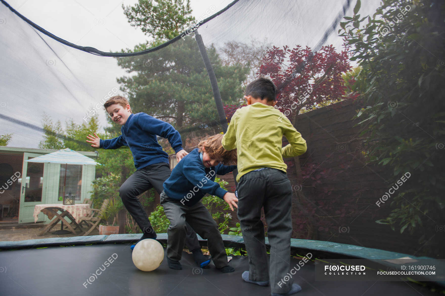 Boys trampoline playing football — happiness, outdoors - Stock | #161900746